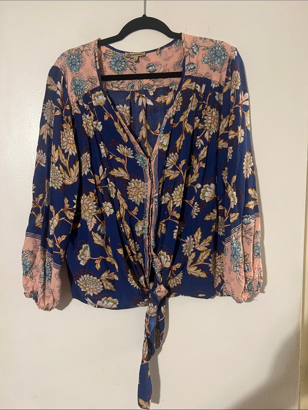 Democracy blue w/ multi color floral hidden button front top. Self tie waist